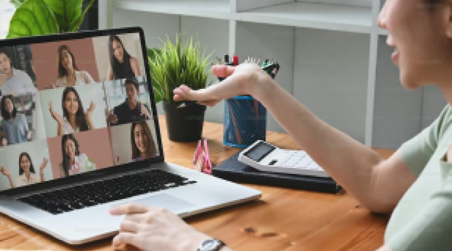 Lady using a computer on a group video call.